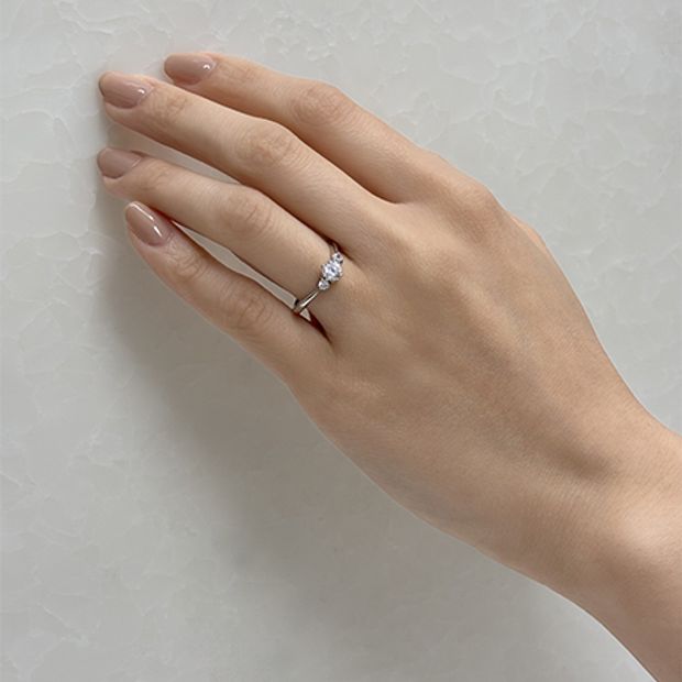 【Over Excellent(オーバーエクセレント)】【Lisianthus bellflower トルコキキョウ-希望-】きゅっと絞られたアームが輝くセンターストーン引き立て、華やかで優美な存在感。