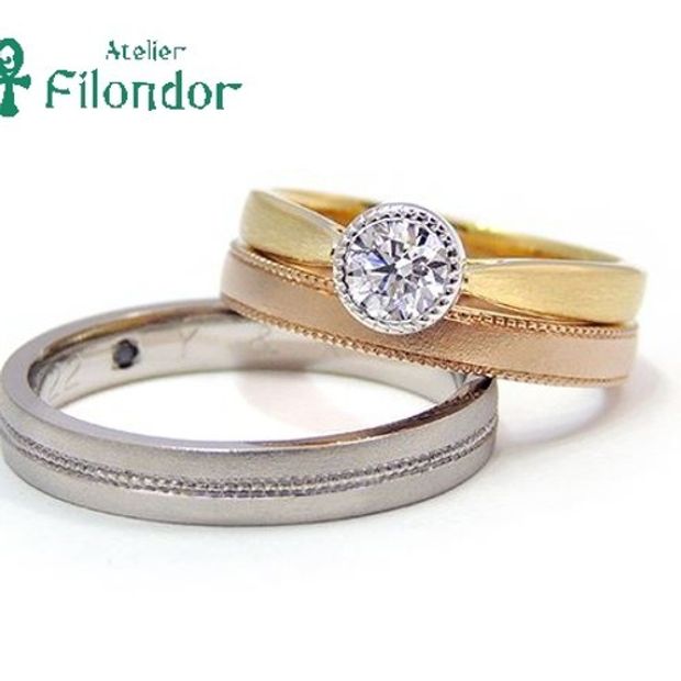 【アトリエフィロンドール】【アトリエ・フィロンドール】ベゼルセッティングのダイアモンドとミル打ち、ゴールドが魅力のエンゲージリング
